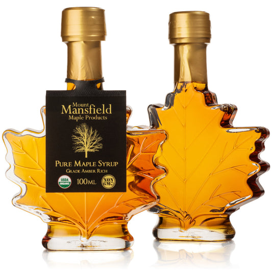 Maple syrup favor bottle, leaf-shaped amber glass with gold cap and Mount Mansfield label.