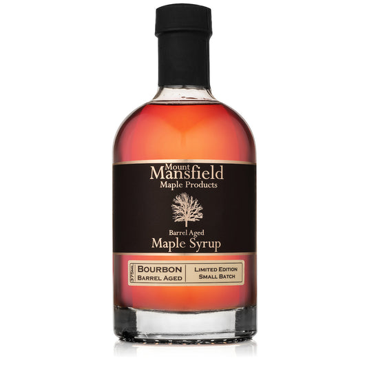 Bourbon barrel-aged maple syrup bottle, black label, amber glass, black cap