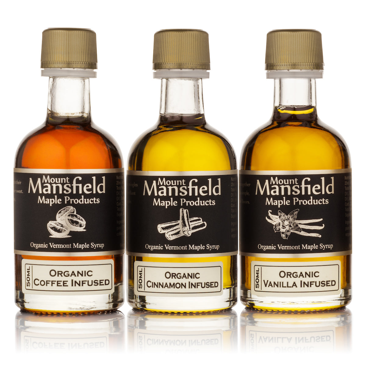 Three Mount Mansfield maple syrup bottles, gold caps, organic coffee, cinnamon, and vanilla infused