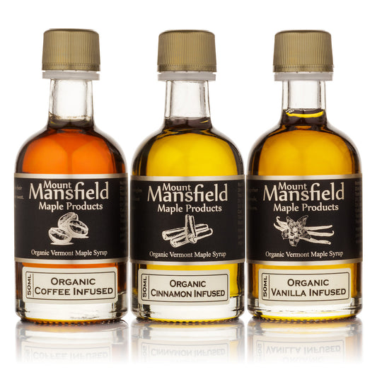 Three Mount Mansfield maple syrup bottles, gold caps, organic coffee, cinnamon, and vanilla infused