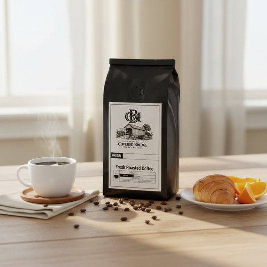 Black coffee bag with front label and small valve on top, Covered Bridge logo